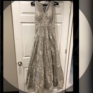 This is a beautiful silver Indian outfit. The work is all over the dress